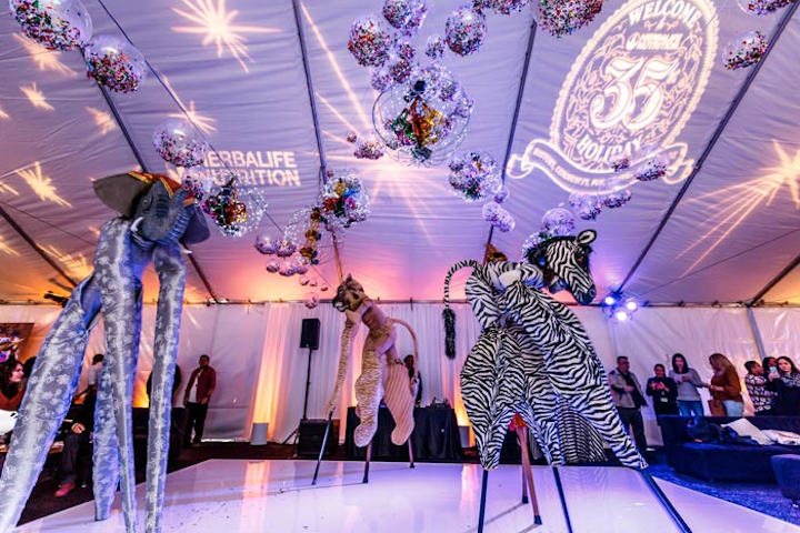 At Herbalife's 2015 holiday party, held at the company’s Torrance, California, offices, Zen Arts provided stilt walkers dressed in elaborate animal costumes to entertain the crowd.