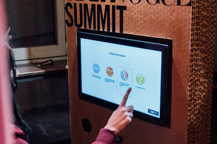 A video booth, which will travel to all five meet-ups, asks attendees how they plan to change the world.
