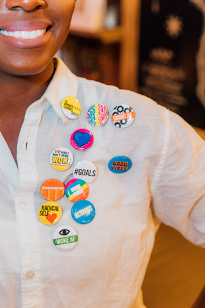 Guests can also grab buttons with cheeky sayings such as “I love naps but I stay woke” and “Smart AF.”