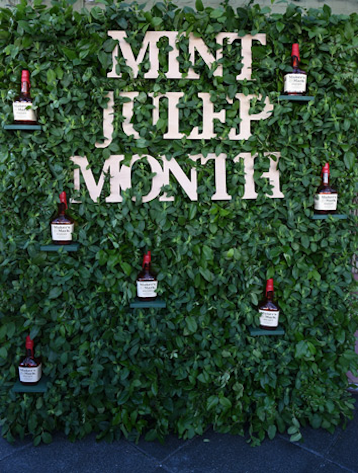 A wall of greenery studded with Maker's Mark bottles served as a backdrop for photos.