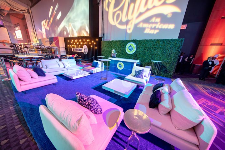 Major sponsor Citi Open's lounge included low-slung couches in bright tennis white and a faux greenery hedge.