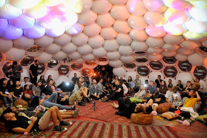Inside the dome, which was decorated with patterned carpets and colorful cushions, Sivan shared anecdotes about his life and his creative process. Studio recordings from the album played as a light show projected images from the album on the dome ceiling.