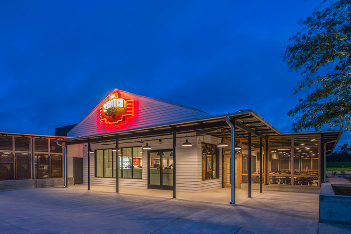 Owners of one of Austin’s favorite barbecue restaurants, Stiles Switch BBQ & Brew, opened a new restaurant out in Dripping Springs in mid-June. The Switch focuses on smoked meats and Cajun cuisine, delivered counter-service-style. The sprawling farmhouse-inspired space, measuring 5,600 square feet inside and 2,500 square feet outside, features bar seating, covered outdoor seating, and a private dining room that fits 100 people. Overall, the space holds 250 people.