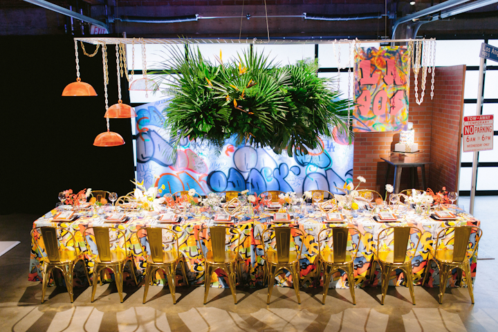 Holly Gray, owner of Anything But Gray Events, created a colorful Los Angeles-inspired space to represent the 1990s. 'As a native myself growing up in this crazy city, I wanted to capture the spirit of my L.A. youth and share it with visitors,' explained Gray. 'City Market Social House, with its industrial floors, glass rolling doors, and 100-year-old brick, was the ideal framework to time travel back to one of the most controversial decades in Los Angeles.' Graffiti artist Odder created a colorful backdrop, and rentals came from Premiere Party Rents and La Piñata Party Rentals. Signs of Our Lives created signage, and Sugar Studio designed a cake with the Los Angeles skyline.