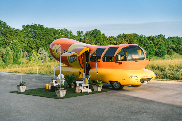 Three pairs of fans are staying in the Oscar Mayer Wienermobile from August 1 to 3 in Evanston, Illinois. The vehicle, which the brand listed on Airbnb to celebrate National Hot Dog day, features an outdoor lawn area for grilling.