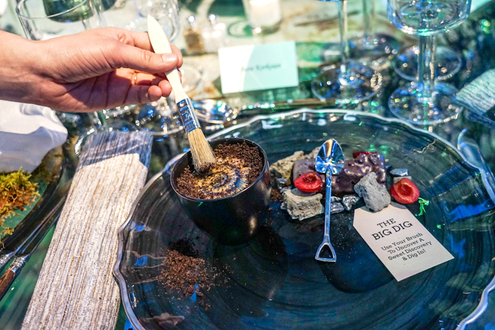 Guests played paleontologists for dessert. Every dish included a brush and a tiny shovel, so guests could excavate a layer of chocolate dust to discover a chocolate disk with an image of a fossil. Under the disk was a sweet treat with chocolate sponge, ganache, Morello cherry mousse, cherries, and whipped cream. Occasions Caterers catered the event. See more: Prehistoric Party: How the Smithsonian Celebrated Its Renovated Fossil Hall