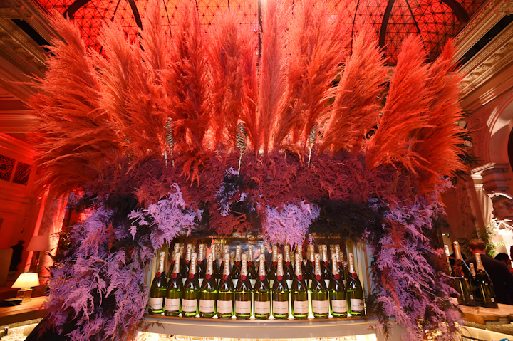 The sixth annual Harper’s Bazaar Icons Party took place September 6 at the Plaza in New York. Champagne sponsor Moet & Chandon was showcased in a dramatic red and purple feather and plant centerpiece at a bar. My Beautiful City designed the event and Brrch handled floral decor.