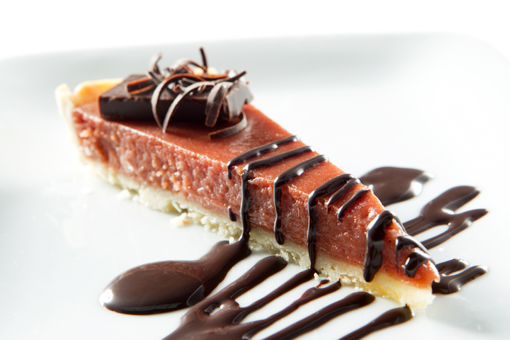 Blood orange cardamom tart with chocolate truffle and dark chocolate sauce, by D’Amico Catering in Minneapolis