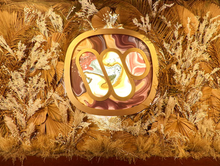 The Warner Music Group logo was creatively displayed throughout the space, including in a wall of neutral florals.