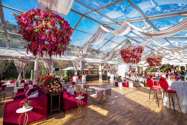 Always a headline-grabbing event, entertainment agency Roc Nation’s annual brunch took place on Saturday at a private estate. The design-forward gathering drew a who’s-who of the music industry, including Beyoncé, Jay-Z, 21 Savage, the Jonas Brothers, Rihanna, and more. So Events designed and produced the brunch, using a colorful palette featuring bold burgundies and subtle blushes inspired by Spain. Inside the main tent were three oversize floral chandeliers, with flowers from Celio’s Design.