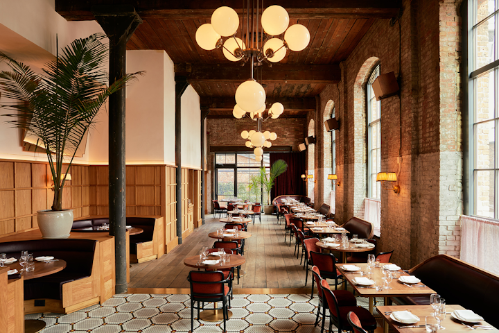 Brooklyn's latest hotspot is Le Crocodile at Wythe Hotel in Williamsburg. The brasserie serves the familiar—steak au poivre and escargots with parsley and Pernod—along with the more ambitious, like a pork chop with kale, anchovies, and burrata and a frisée salad studded with smoked eel instead of lardons. The restaurant, which opened in December, seats 100 people in a space with burgundy leather booths, a marble bar, and exposed brick walls original to the 120-year-old factory building. Le Crocodile provides catering for all of the hotel's venues, which include the 2,100-square-foot Main Hall that seats 140 for dinners or holds 250 for receptions. It can be combined with the Garden Terrace to seat 200 for dinners or cocktails. Another unique space at the hotel is the screening room and bar, which seats 70 guests in a theater setup for screenings or presentations and has a private entrance.