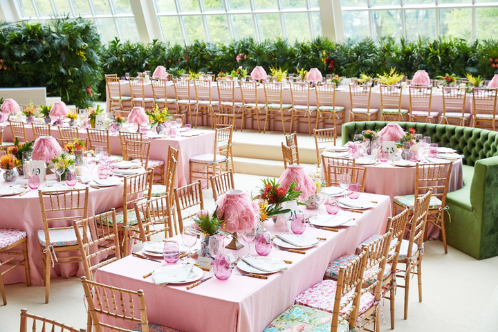 The 2019 Costume Institute Benefit featured a camp theme with pink decor galore. Raul Avila, who has produced the benefit decor since 2007, created the design for the benefit in collaboration with Jan Versweyveld, who designed the exhibition, Camp: Notes on Fashion. Avila went with natural wood ballroom chairs that featured cushions covered with six different flamingo-printed patterns. The centerpieces contained tropical plants including a variety of ginger species. Pink tablecloths were set with chargers printed with floral branches, painted pink glassware, bamboo flatware, feather-decorated lampshades, and napkins embroidered with pink flamingos.