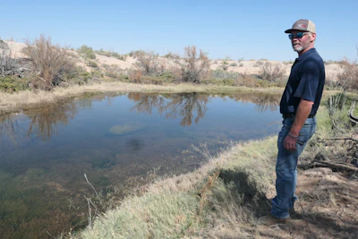 Eric Selinger stands alongside the Pecos River on Oct. 8. He hopes produced water could help the agricultural industry grow in Pecos County.