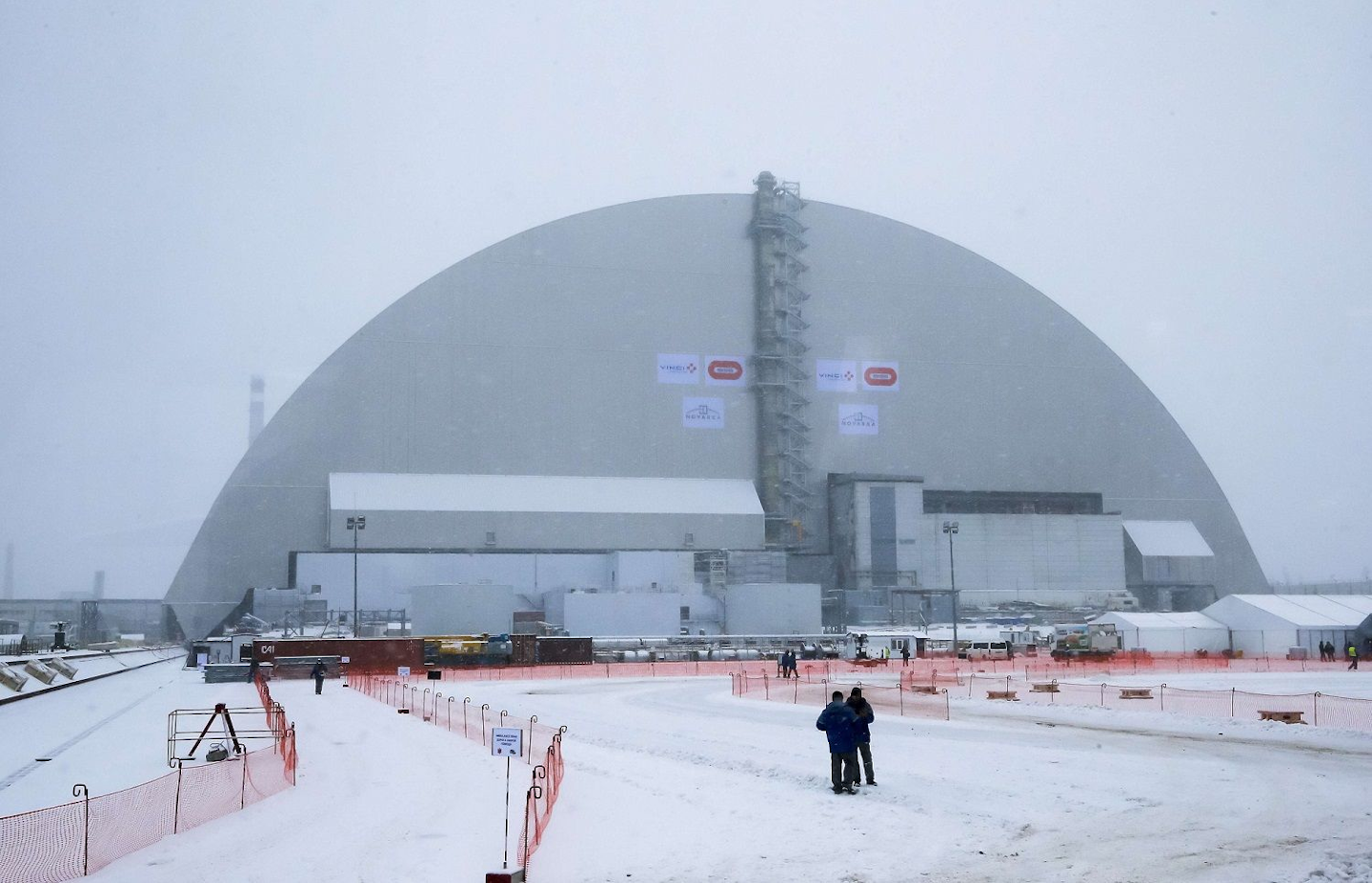 Workers inspect the New Safe Confinement (NSC) movable enclosure at the nuclear power plant in Chernobyl, Ukraine, Tuesday, Nov. 29, 2016. The NSC enclosure has slowly begun to move towards covering the Chernobyl nuclear reactor, in what represents a significant step toward liquidating the remains of the world's worst nuclear accident. (AP Photo/Efrem Lukatsky)