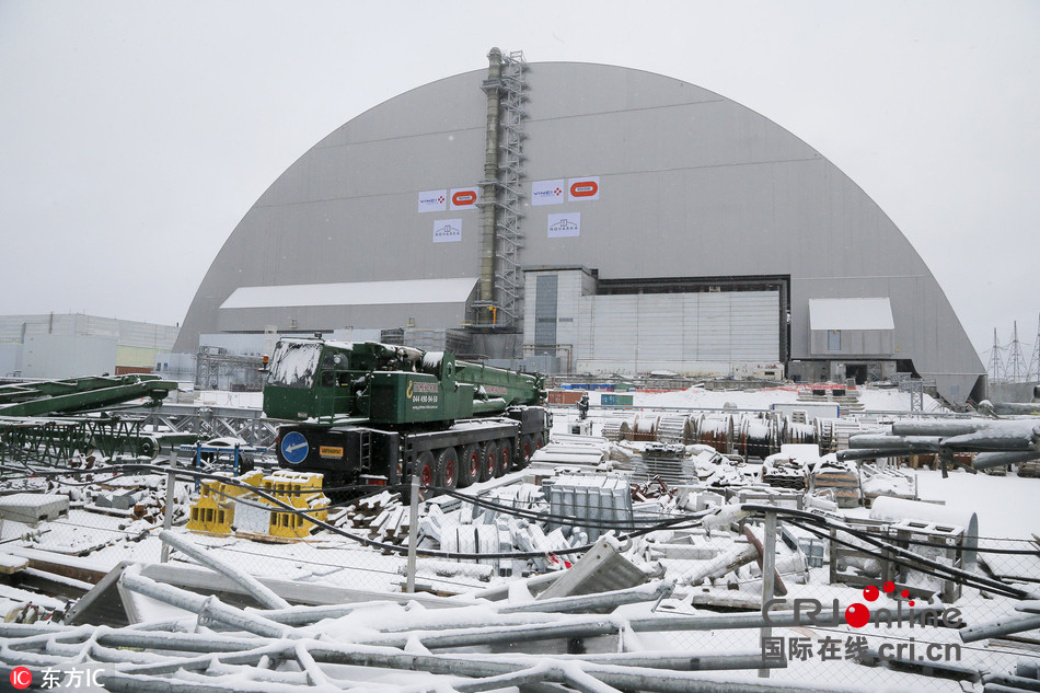A view of the half-cylinder-shaped enclosure in Chernobyl, Ukraine, Tuesday, Nov. 29, 2016. A massive shelter has finally been installed over the exploded reactor at the Chernobyl nuclear plant, one of the most ambitious engineering projects in the world. The half-cylinder-shaped shelter began being moved toward the reactor on a system of hydraulic jacks two weeks ago and reached its destination Tuesday, a significant step toward liquidating the remains of the world's worst nuclear accident, 30 years ago in what is now Ukraine. (AP Photo/Efrem Lukatsky)
