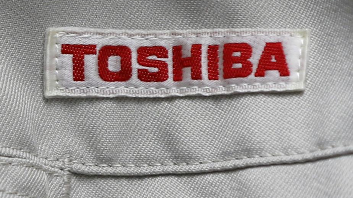 In this Thursday, June 15, 2017, photo, the logo of Toshiba Corp., Japan's electronics and energy company, is seen on a worker's jacket in Yokosuka, near Tokyo. Tokyo-based Toshiba, whose U.S. nuclear unit Westinghouse Electric Co. filed for bankruptcy protection in March, said Friday it received an extension until Aug. 10 to give its earnings report for the fiscal year that ended in March. (AP Photo/Shuji Kajiyama, File)