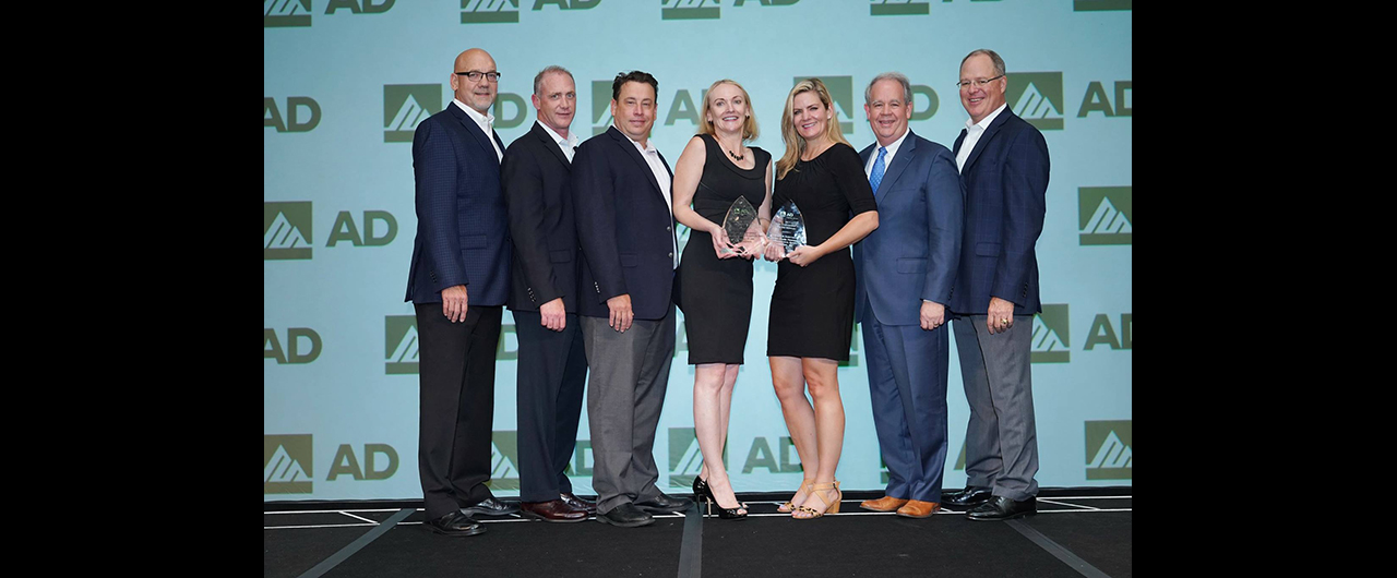 Members of Industrial Supply Company and Kimberly Clark accept AD Industrial's award for Best Conversion for Safety.