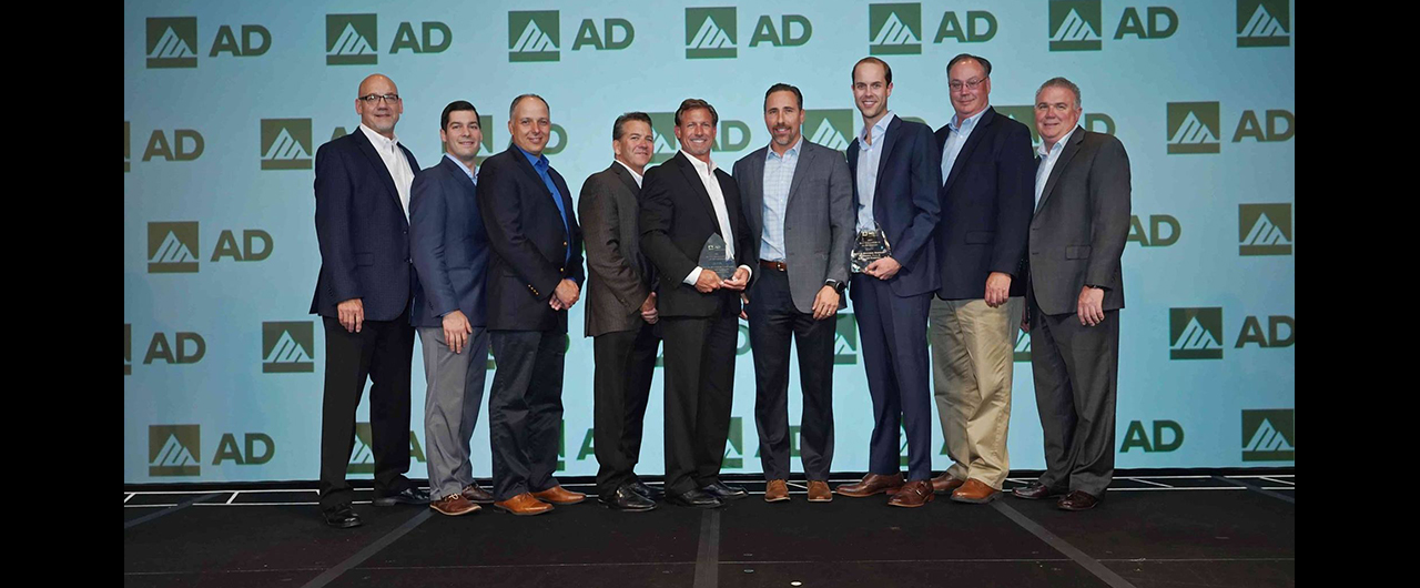 Members of Milwaukee Tool and Black & Company accept AD Industrial's award for 2017 Best AD Conversion for Tools & Material Handling.