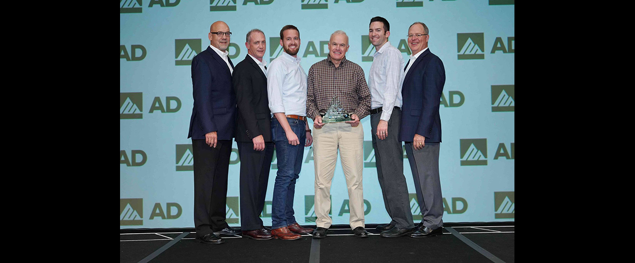 Members of P&I Supply accept AD Industrial's award for Tier 2 Member of the Year.