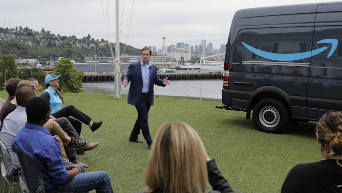 Dave Clark, senior vice president of worldwide operations for Amazon.com, talks to reporters, Wednesday, June 27, 2018, in Seattle, at a media event for Amazon to announce a new program that lets entrepreneurs around the country launch businesses that deliver Amazon packages. Image credit: AP Photo/Ted S. Warren