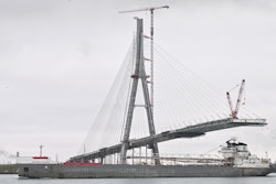 The freighter Manitowoc passes by construction on the Gordie Howe International Bridge, Detroit, Dec. 29, 2023.