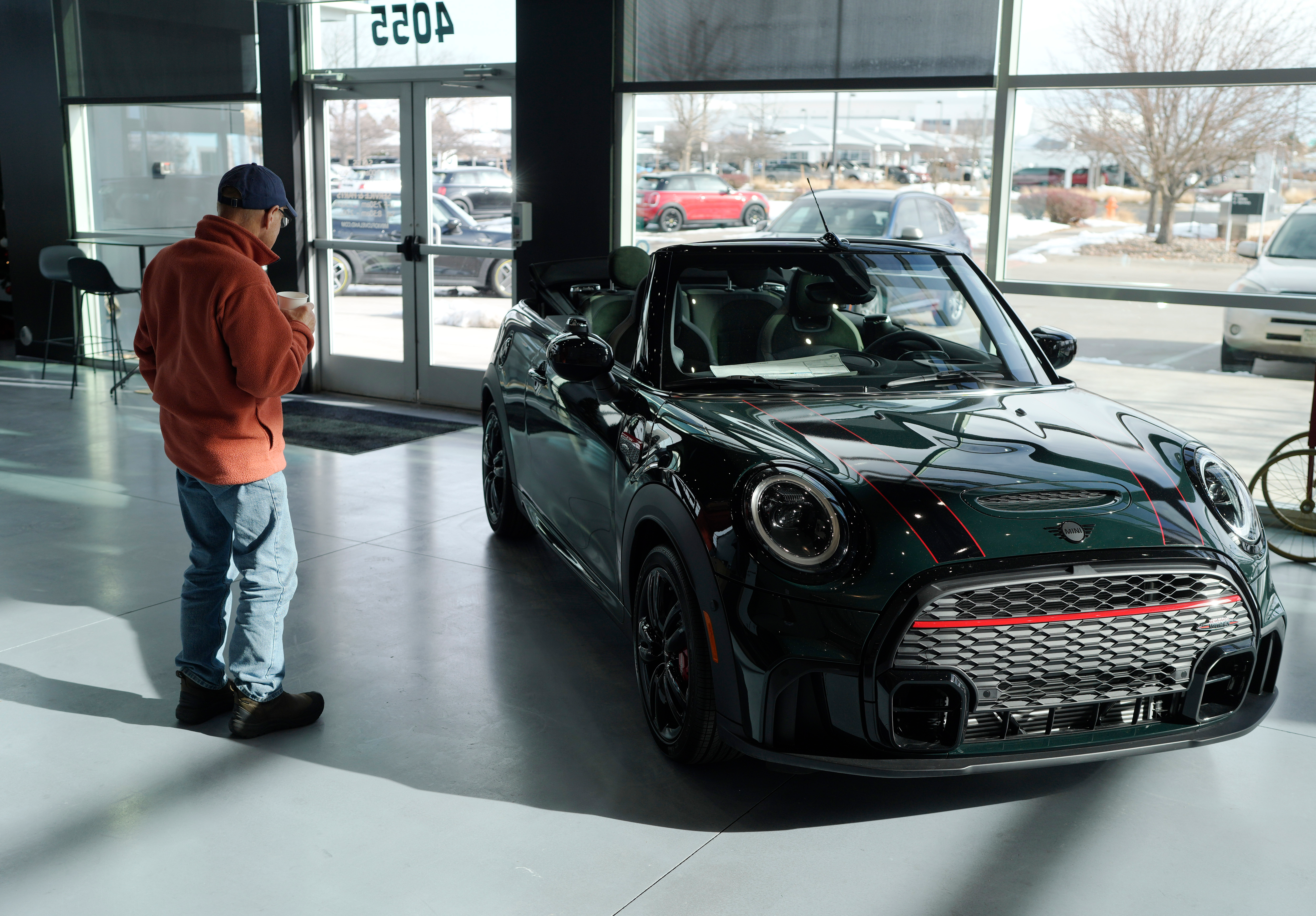 A man looks at a 2024 Cooper S John Cooper Works convertible at a Mini dealership on Nov. 30, 2023, in Loveland, Colo.