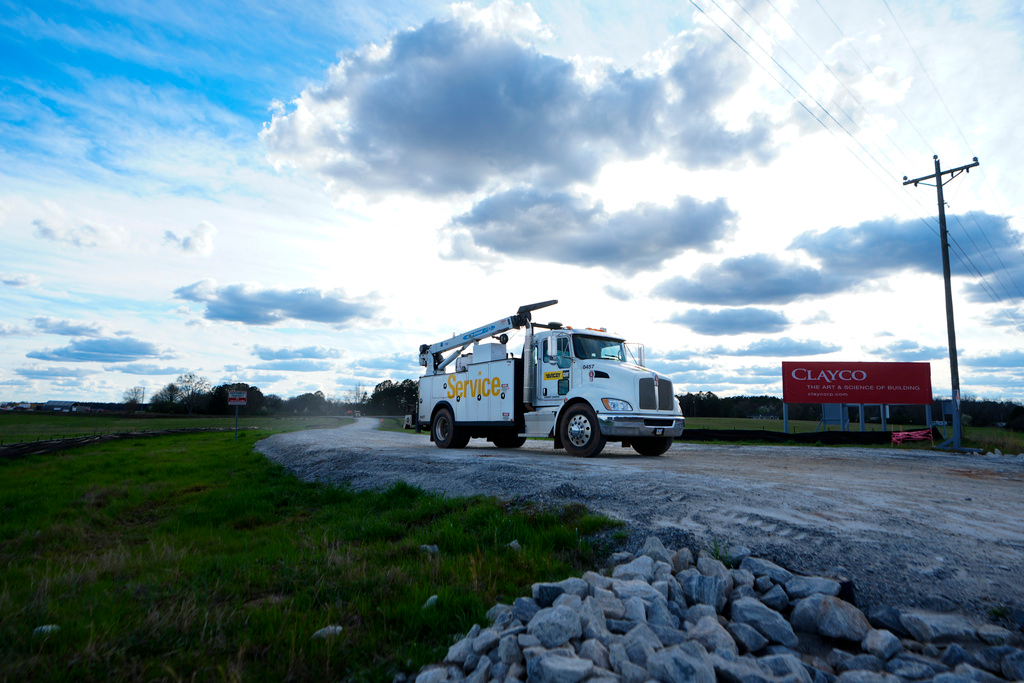 A truck leaves the site of a planned Rivian electric truck plant Thursday, March 7, 2024, in Rutledge,Ga.