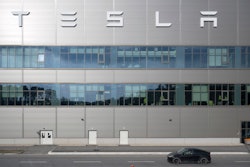A vehicle from the security service drives by the Tesla car factory after production came to a standstill and workers were evacuated following a power outage, in Grünheide, Germany, Tuesday, March 5, 2024.