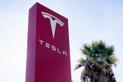 A Tesla sign is seen at a dealership, Dec. 3, 2023, in Buena Park, Calif.