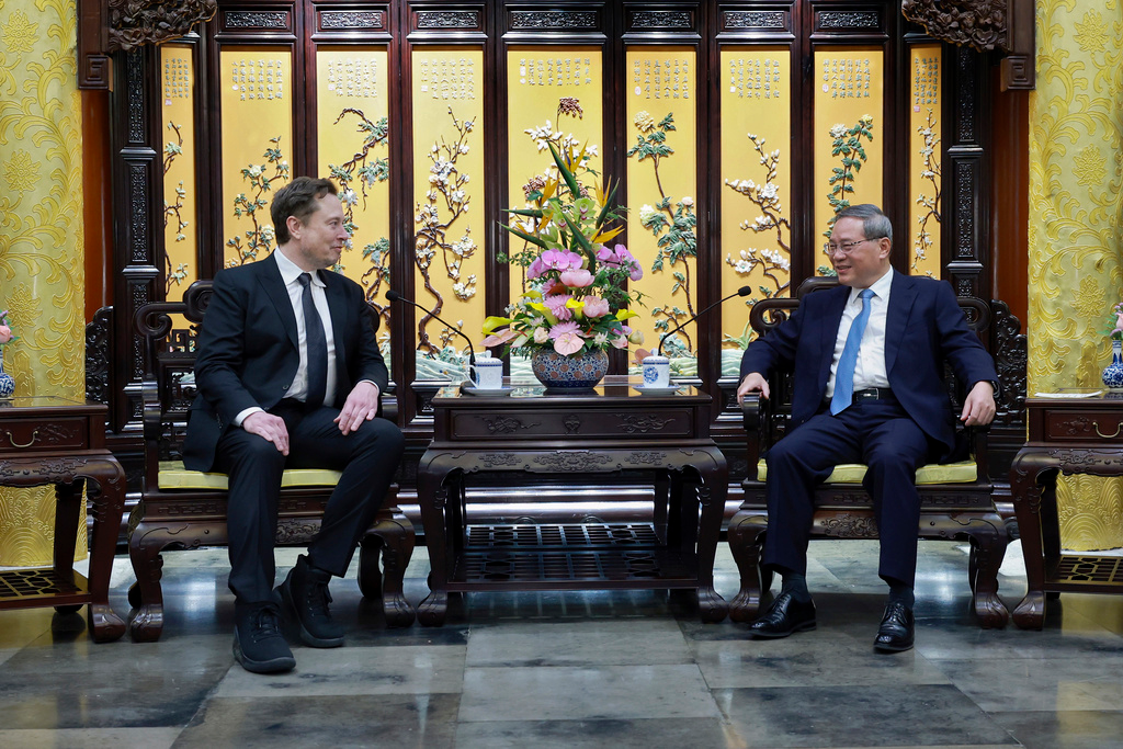 In this photo released by Xinhua News Agency, visiting Tesla founder and CEO Elon Musk, left, meets with Chinese Premier Li Qiang in Beijing, Sunday, April 28, 2024. Musk met with a top government leader in the Chinese capital Sunday, just as the nation's carmakers are showing off their latest electric vehicle models at the Beijing auto show.