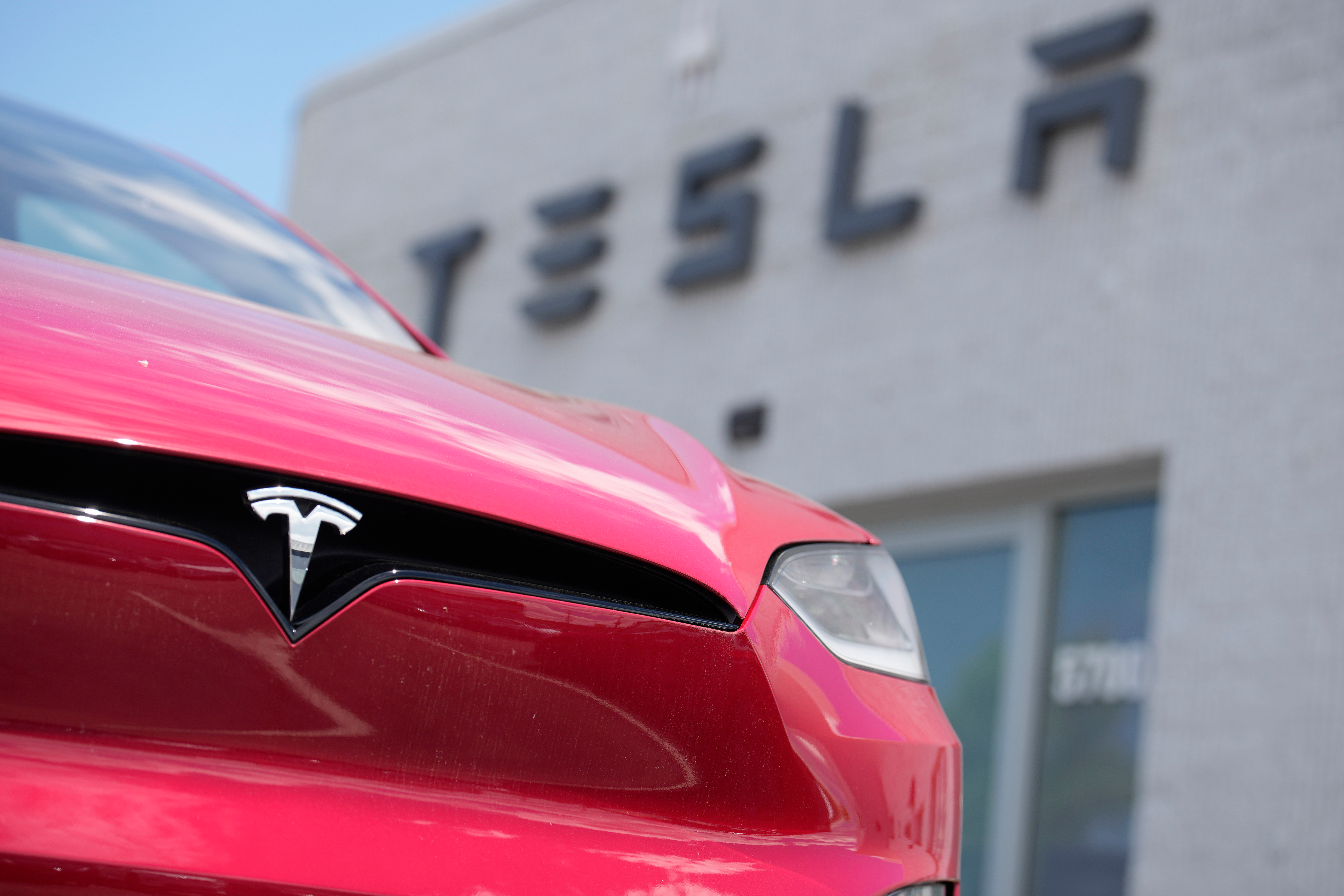 A Model X sports-utility vehicle sits outside a Tesla store in Littleton, Colo., June 18, 2023.