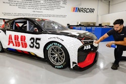CJ Tobin, senior engineer of vehicle systems, cleans a prototype of the first electric racecar at the NASCAR R&D Center in Concord, N.C., Monday, July 1, 2024. The top motorsports series in North America partnered with Chevrolet, Ford, Toyota and electrification company ABB to demonstrate a high-performance electric vehicle and gauge fan interest in electric racing.