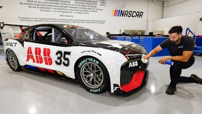 CJ Tobin, senior engineer of vehicle systems, cleans a prototype of the first electric racecar at the NASCAR R&D Center in Concord, N.C., Monday, July 1, 2024. The top motorsports series in North America partnered with Chevrolet, Ford, Toyota and electrification company ABB to demonstrate a high-performance electric vehicle and gauge fan interest in electric racing.