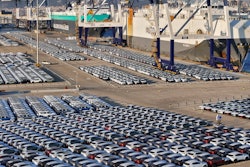 New cars for export wait for transportation on a vehicles carrier vessel at a dockyard in Yantai in east China's Shandong province.