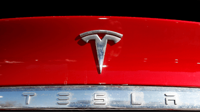 The Tesla logo appears on an unsold 2020 Model X at a dealership, Feb. 2, 2020, in Littleton, Colo.