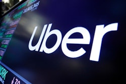 The Uber logo appears above a trading post on the floor of the New York Stock Exchange.