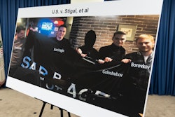 A photo of Russian suspects wanted by the FBI involved in a conspiracy to commit criminal cyber activities against Ukrainian government systems is displayed during a press conference at the Office of the United States Attorney in Baltimore, Thursday, Sept. 5, 2024.