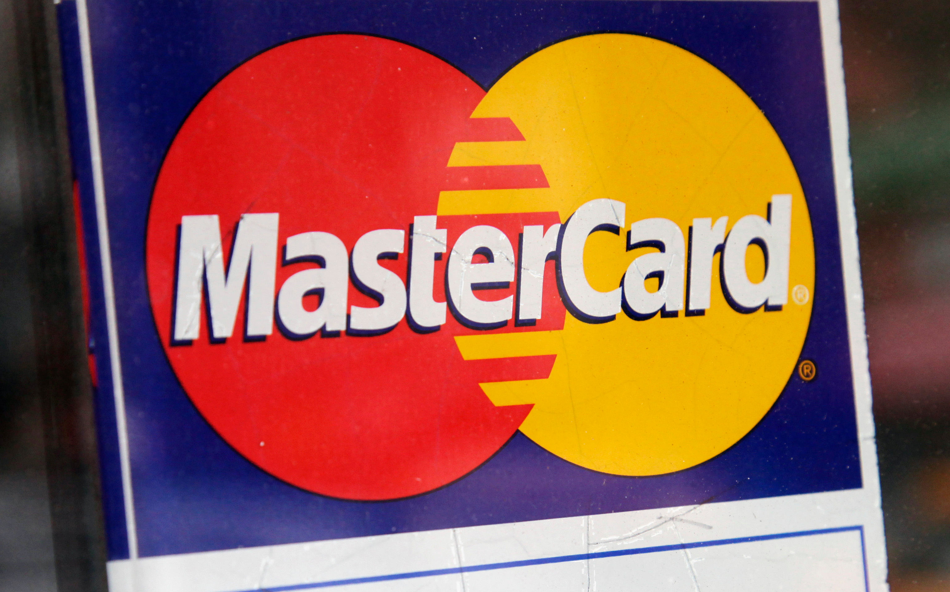 A sign indicating MasterCard credit cards are accepted is posted at a New York business, Jan. 21, 2015.