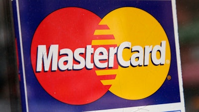 A sign indicating MasterCard credit cards are accepted is posted at a New York business, Jan. 21, 2015.