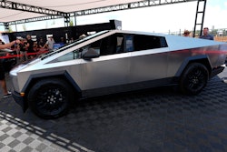 Visitors look over a 2024 Cybertruck in the Tesla display at the Electrify Expo, July 14, 2024, in north Denver.