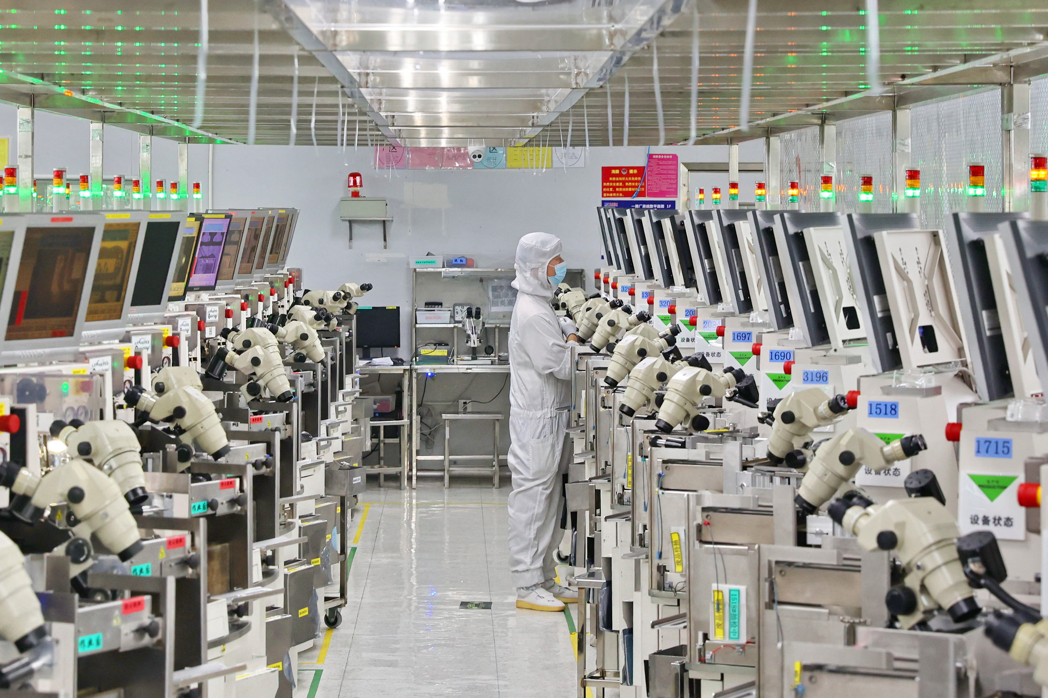 A man works at a manufacturer of Integrated Chip encapsulation in Nantong in eastern China's Jiangsu province on Friday, Sept. 16, 2022.