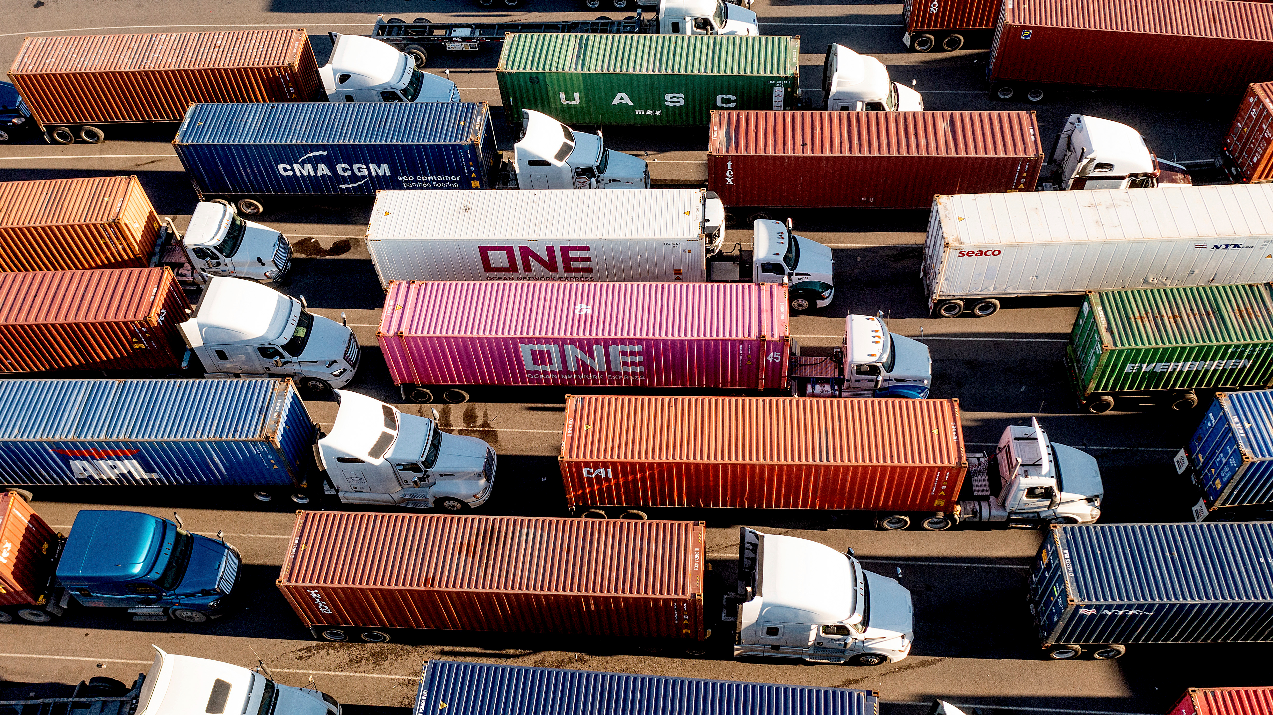Trucks line up to enter a Port of Oakland shipping terminal in Oakland, Calif., Nov. 10, 2021.