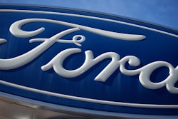 The Ford company logo is seen, Oct. 24, 2021, on a sign at a Ford dealership in southeast Denver.
