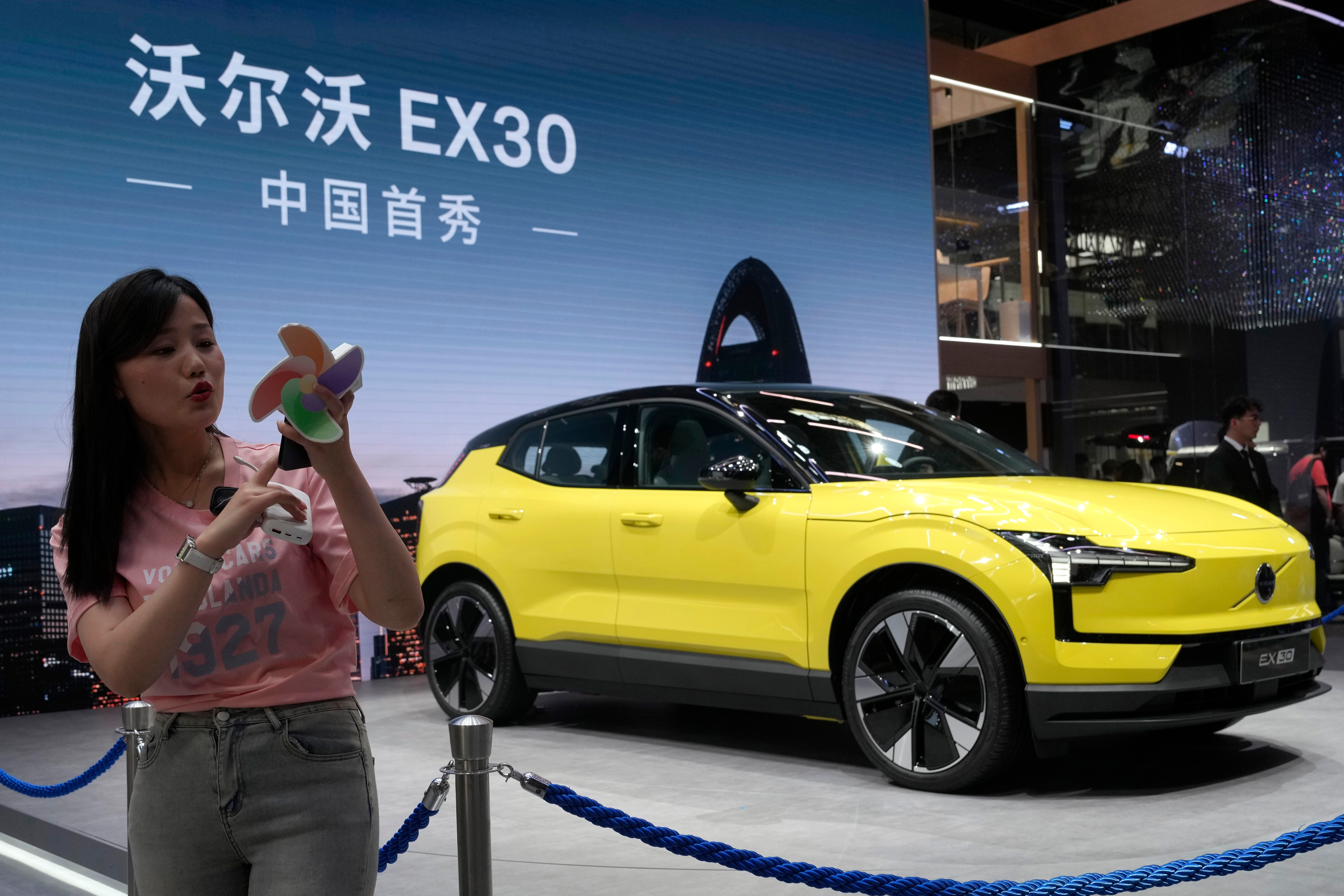 A live streamer works near the Volvo EX30 fully electric small SUV unveiled during Auto China 2024 in Beijing, Thursday, April 25, 2024.