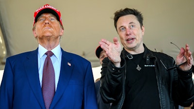 President-elect Donald Trump listens to Elon Musk as he arrives to watch SpaceX's mega rocket Starship lift off for a test flight from Starbase in Boca Chica, Texas, Nov. 19, 2024.