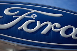 The Ford company logo is seen, Oct. 24, 2021, on a sign at a Ford dealership in southeast Denver.