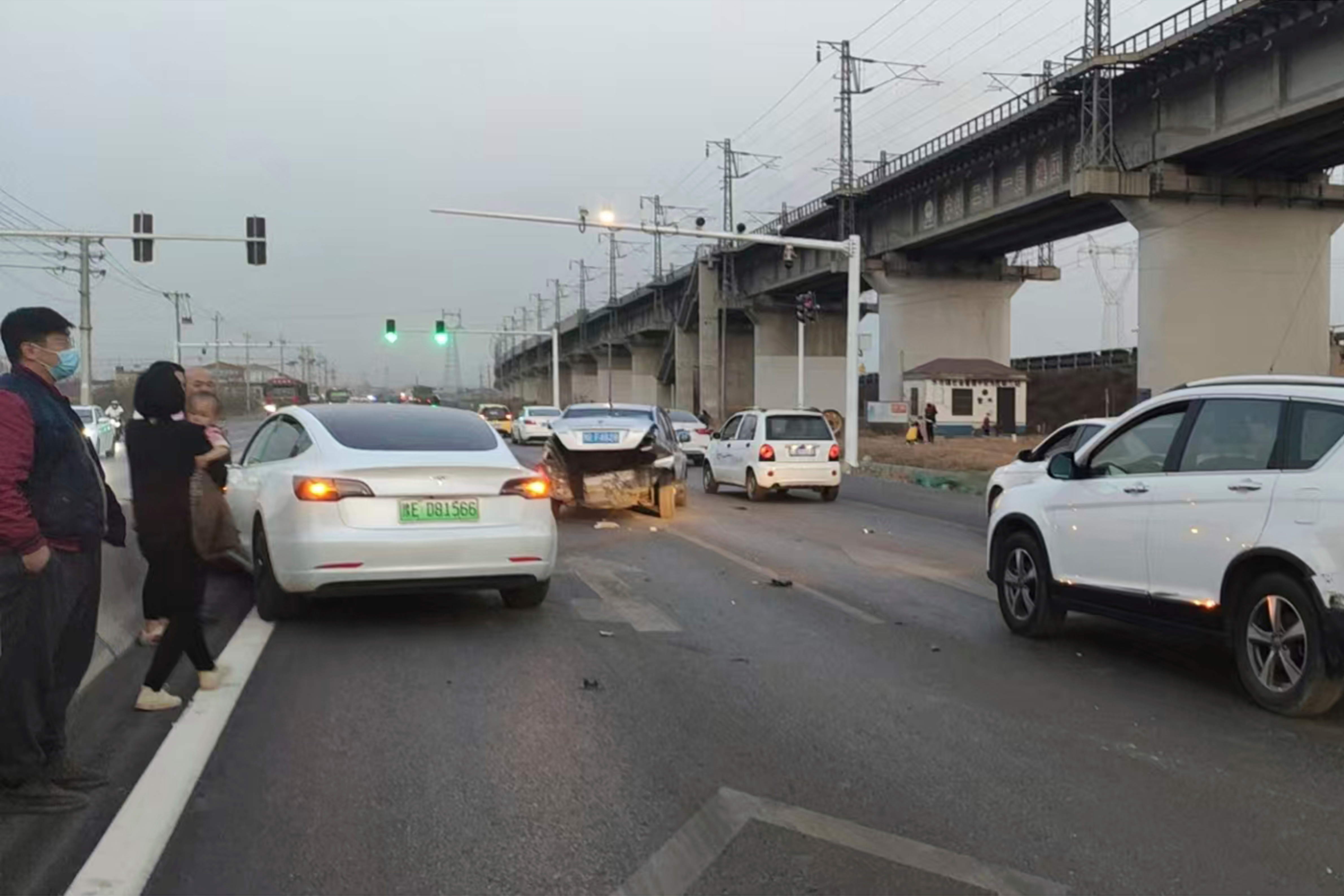 This photo provided by Zhang Yazhou shows her damaged Tesla Model 3, left, which her father was driving when it hit two other cars before crashing to a halt against a concrete barrier in Anyang, a city in central China&rsquo;s Henan province, on Feb. 21, 2021. Zhang was in the passenger seat. Her mother and her one-year-old niece were at the back.