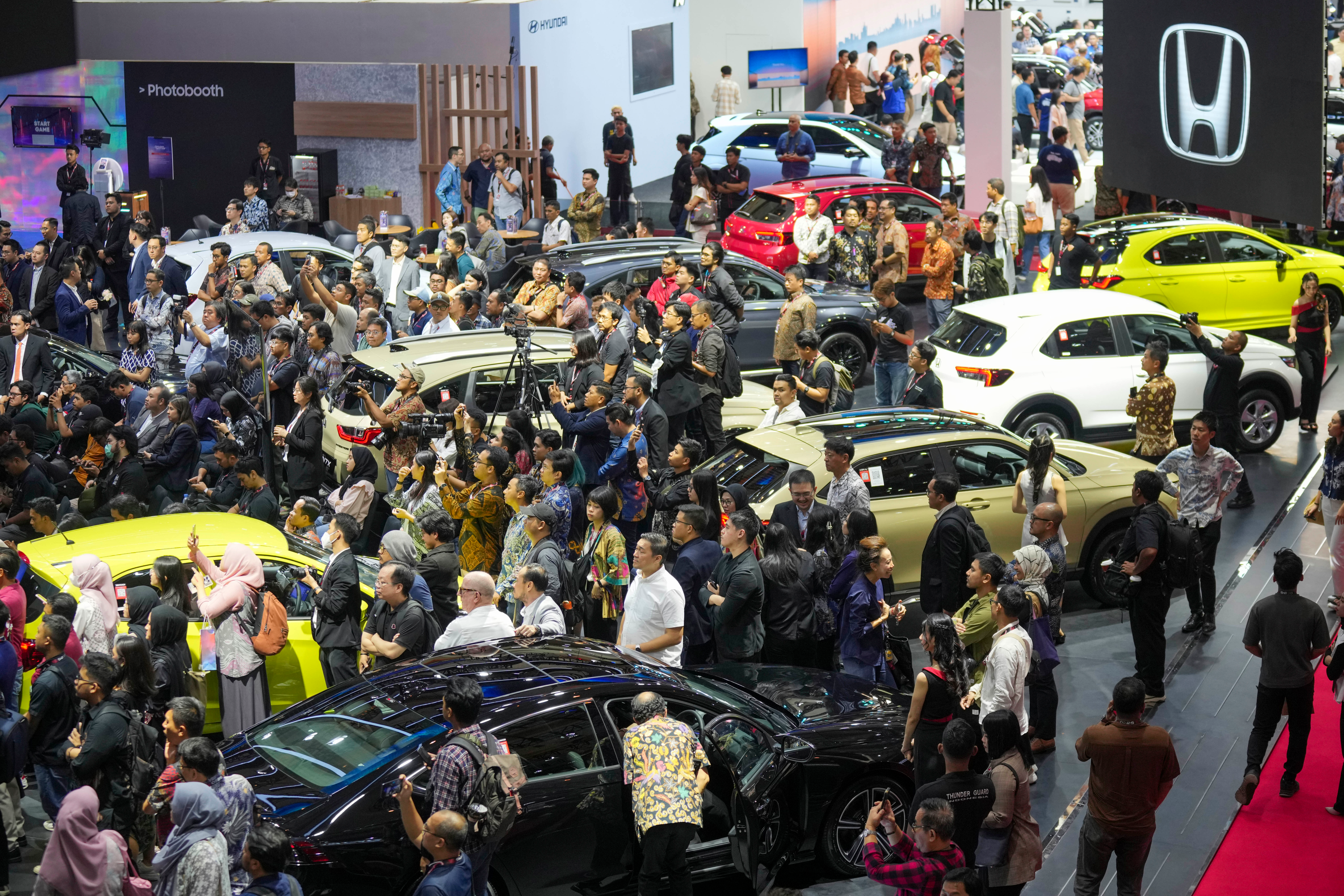 Visitors look at vehicles during the Indonesian International Motor Show in Jakarta, Indonesia, Thursday, Feb. 13, 2025.