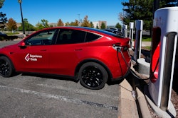 A Tesla Model 3 charges at a Tesla supercharging station situated in the parking lot of an outlet mall on Sept. 25, 2024, in Lakewood, Colo.
