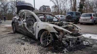 A burnt-out Tesla car stands in the Steglitz district of Berlin, Friday, March 14, 2025, as four Teslas are suspected to have been set on fire in Berlin last night.